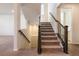 Elegant staircase with dark wood railings and carpeted steps at 27255 E Alder Dr, Aurora, CO 80016