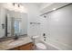 Bathroom with granite vanity, toilet and bathtub at 6153 N Ceylon St # 303, Denver, CO 80249