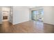 Bright bedroom with wood-look flooring and access to a private balcony at 6153 N Ceylon St # 303, Denver, CO 80249