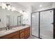 Double vanity bathroom with granite countertops and a large shower at 6153 N Ceylon St # 303, Denver, CO 80249