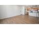 Spacious living room with hardwood floors and kitchen view at 6153 N Ceylon St # 303, Denver, CO 80249