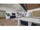 Open-concept living room with fireplace and kitchen island at 5061 Moss Pl, Golden, CO 80403
