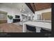 Open living room with fireplace, large windows, and kitchen access at 5061 Moss Pl, Golden, CO 80403