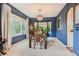 Elegant dining room with a dark wood table and blue walls at 574 Castle Pines S Dr, Castle Rock, CO 80108