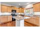 Modern kitchen with an island, granite countertops, and wood flooring at 4572 Walden Way, Denver, CO 80249