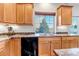 Kitchen features a double sink, dishwasher, and backyard view at 4572 Walden Way, Denver, CO 80249