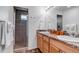 Double vanity bathroom with shower, granite countertop and wood cabinets at 4572 Walden Way, Denver, CO 80249