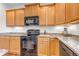 View of kitchen range, microwave, and cabinetry at 4572 Walden Way, Denver, CO 80249