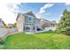 Spacious backyard with patio, grass, and a privacy fence at 4572 Walden Way, Denver, CO 80249