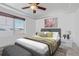 Spacious bedroom with large window, ceiling fan, and neutral decor at 4572 Walden Way, Denver, CO 80249