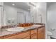 Modern bathroom with double sinks, granite countertops, and a large mirror at 4572 Walden Way, Denver, CO 80249