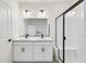 Modern bathroom with double sinks, a large mirror, and a glass shower at 9360 Bahama Ct, Commerce City, CO 80022