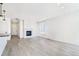 Bright living room with hardwood floors and a modern fireplace at 9360 Bahama Ct, Commerce City, CO 80022