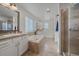 Main bathroom with soaking tub, shower, and double vanity at 12939 Norway Maple St, Parker, CO 80134