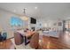 Open concept dining area with hardwood floors, a modern light fixture, and wood table at 12939 Norway Maple St, Parker, CO 80134