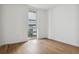 Simple bedroom with hardwood floors and access to balcony at 3575 Chestnut Pl # 403, Denver, CO 80216