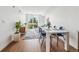 Bright dining area with modern table and chairs, hardwood floors at 3575 Chestnut Pl # 403, Denver, CO 80216