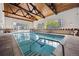 Indoor swimming pool with a wood-beamed ceiling at 6930 E Girard Ave # 207, Denver, CO 80224