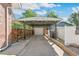Carport with attached garage and side yard access at 1538 Oneida St, Denver, CO 80220