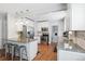 Modern kitchen with granite countertops, stainless steel appliances, and white cabinets at 1538 Oneida St, Denver, CO 80220