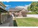 Brick home with large backyard, patio, and detached garage at 1538 Oneida St, Denver, CO 80220