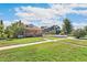 House exterior showcasing a brick home with a spacious lawn at 1538 Oneida St, Denver, CO 80220