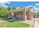 Brick house with front porch, steps, and landscaping at 1538 Oneida St, Denver, CO 80220