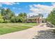 Brick house with driveway and landscaping at 1538 Oneida St, Denver, CO 80220
