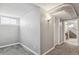 Finished basement hallway with access to laundry and stairs at 1538 Oneida St, Denver, CO 80220