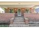 Brick house with a front porch and steps leading to the entrance at 1538 Oneida St, Denver, CO 80220