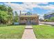 Charming brick home with a well-manicured lawn and walkway at 1538 Oneida St, Denver, CO 80220