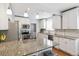 Modern kitchen with granite countertops, stainless steel appliances, and white cabinets at 1538 Oneida St, Denver, CO 80220