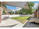 Large backyard with patio, grass, shade sail, and grill at 1538 Oneida St, Denver, CO 80220