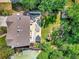 Aerial view of a backyard with a patio, play area, and lush greenery at 1140 Nottingham St, Lafayette, CO 80026