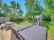 Spacious backyard with hot tub, play area, and lush greenery at 1140 Nottingham St, Lafayette, CO 80026