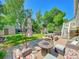 Large concrete patio with seating area, fire pit, and umbrella at 1140 Nottingham St, Lafayette, CO 80026