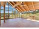 Sunroom with tiled floors, vaulted ceiling, and walls of windows offering scenic views at 102 Staghorn Way, Franktown, CO 80116
