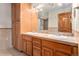Large bathroom with double sinks, wood cabinets, and tile flooring at 102 Staghorn Way, Franktown, CO 80116