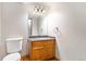 Small bathroom with granite countertop, wood cabinets, and a toilet at 102 Staghorn Way, Franktown, CO 80116