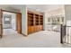 Upper hallway with built-in wooden shelves and carpeting at 102 Staghorn Way, Franktown, CO 80116