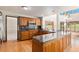 Spacious kitchen with an island, wood cabinets, and granite countertops at 102 Staghorn Way, Franktown, CO 80116