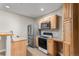 Basement kitchenette with wood cabinets and appliances at 102 Staghorn Way, Franktown, CO 80116