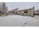 Snow-covered backyard, showing playset and shed at 14931 E 117Th Ave, Commerce City, CO 80603