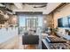 Spacious living room with exposed brick, hardwood floors, and city views at 2020 Arapahoe St # 950, Denver, CO 80205