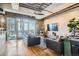 Living room with hardwood floors, exposed beams, city views, and modern furniture at 2020 Arapahoe St # 950, Denver, CO 80205