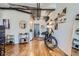Open concept living room with hardwood floors, exposed beams, and modern decor at 2020 Arapahoe St # 950, Denver, CO 80205
