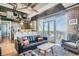 Open concept living area with kitchen, exposed beams, and modern furnishings at 2020 Arapahoe St # 950, Denver, CO 80205