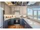 Open concept kitchen with dark gray cabinets and ample counter space at 2020 Arapahoe St # 950, Denver, CO 80205