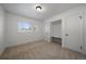 Bright bedroom with neutral carpet, built-in desk, and ample natural light at 3379 S Flamingo Way, Denver, CO 80222