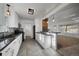 Modern kitchen featuring white cabinetry, dark granite countertops, and stainless steel appliances at 3379 S Flamingo Way, Denver, CO 80222